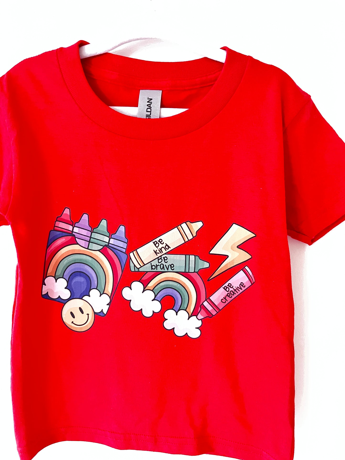 Red t-shirt with colorful graphic design on a white background