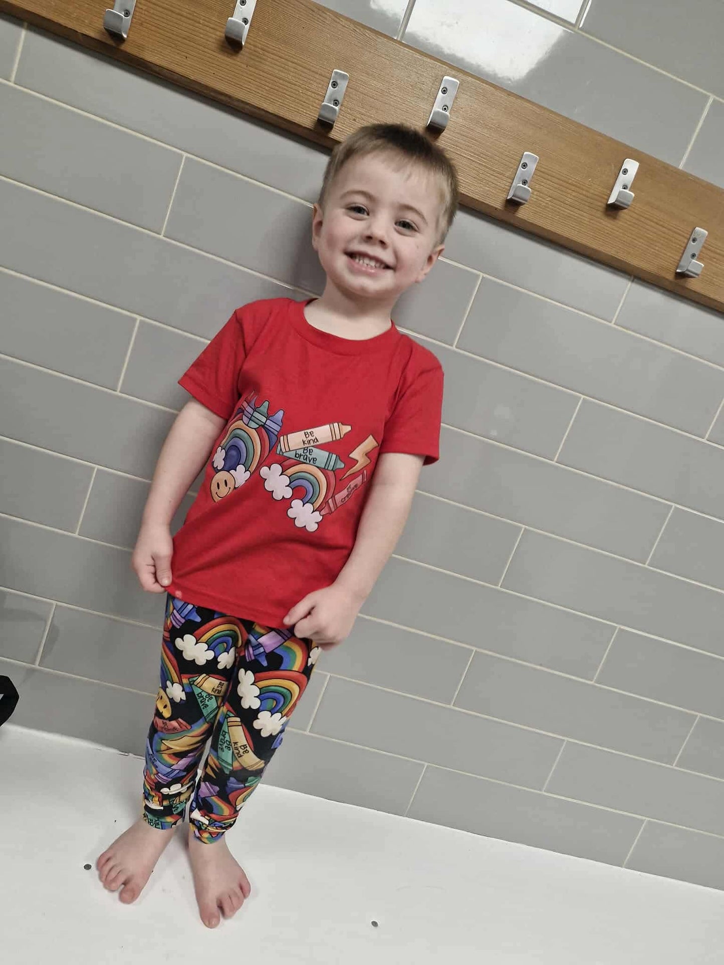child wearing rainbow crayon printed T-shirt happy smiling 
